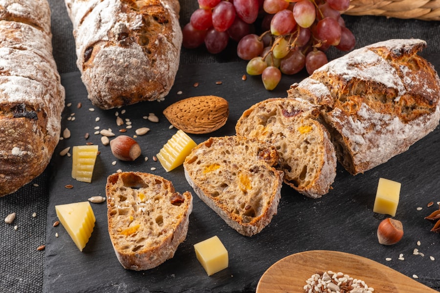 Floured loaves with cubes of cheese on a slate board